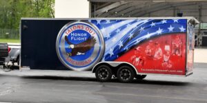 A large rectangular trailer with an eagle and American flag painted on the side.
